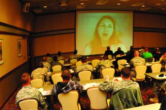 people seated watching a video