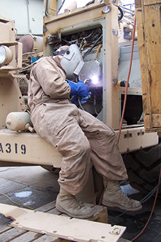 Add-on team installs newly created armor kits (photo courtesy of www.army.mil)