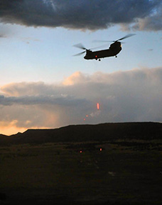 A CH-47 Chinook helicopter from 2nd Battalion, 135th General Support Aviation fires tracer rounds at ground targets (photo courtesy of www.army.mil)