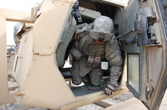 A Soldier exits a Humvee Egress Assistance Trainer after being turned upside down. The simulation creates more realistic disorientation and battlefield conditions, and improves a Soldier's ability to exit his tactical vehicle quickly and safely. (photo courtesy of www.army.mil)