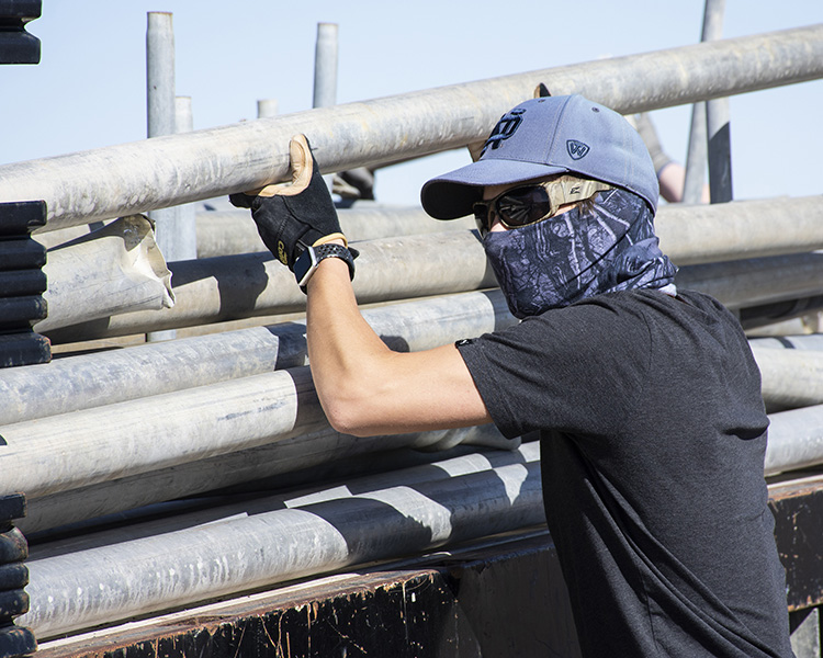 Christian Courtney of Jacobs fits a length of irrigation pipe into the back of a truck, salvaged from a test conducted years ago. Its all part of concerted spring cleaning of test sites and around facilities. Photo by Al Vogel, Dugway Public Affairs