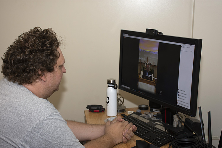 John Melnyczuk watches the Easter Sunrise Service live in his dorm room. The COVID-19 pandemic required the service not be attended, while inclement weather kept it from being outdoors. Photo by Al Vogel, Dugway Public Affairs