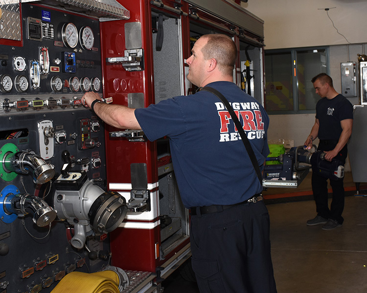 Firefighters at Dugway Proving Ground maintain a proper social distance of at least 6 feet while restocking an engine after returning from a small range fire. Photo by Al Vogel, Dugway Public Affairs.