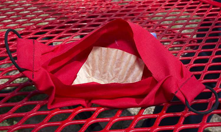 Lt. Brandon Roschewski of the Dugway Fire Department has made dozens of this facial mask for his fellow firefighters. The mask accommodates a coffee filter inside, for protection against the wearer sneezing or coughing. Roschewski makes the masks in his small room at the fire station. He brings his sewing machine from home. Photo by Al Vogel, Dugway Public Affairs.