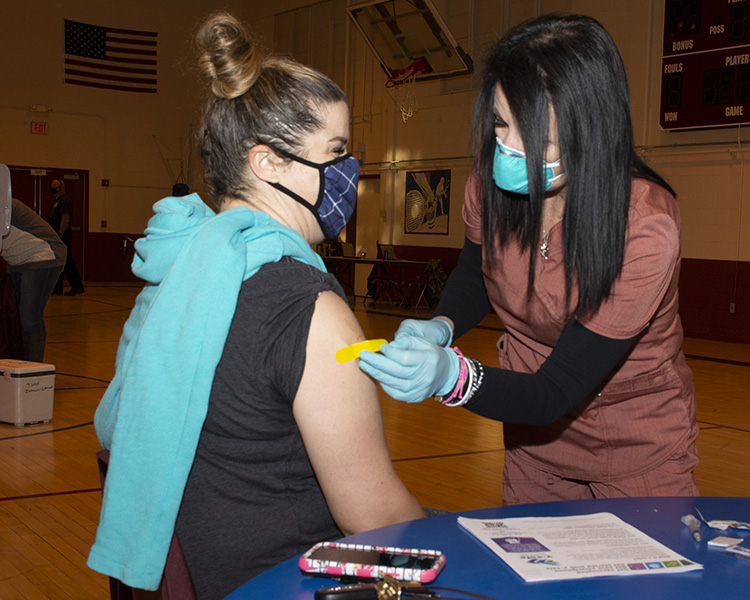 Cecilia Murphy, management and program analyst at Dugway Proving Ground, received an adhesive bandage over her vaccination site Feb. 22, 2021 from Cammy Gunderson, medical technician. More DoD Prioritized inoculations were given March 1, 3 and 4. Photo by Al Vogel, Dugway Public Affairs