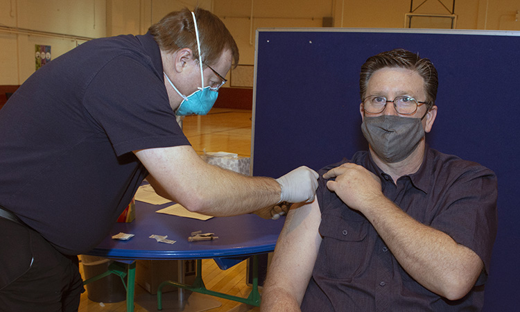 Grant Price, process improvement specialist, received his first COVID-19 vaccination Feb. 22, 2021 from Sage Farmer, occupational health technician. Two inoculations, at least 28 days apart, were required for full protection. Photo by Al Vogel, Dugway Public Affairs