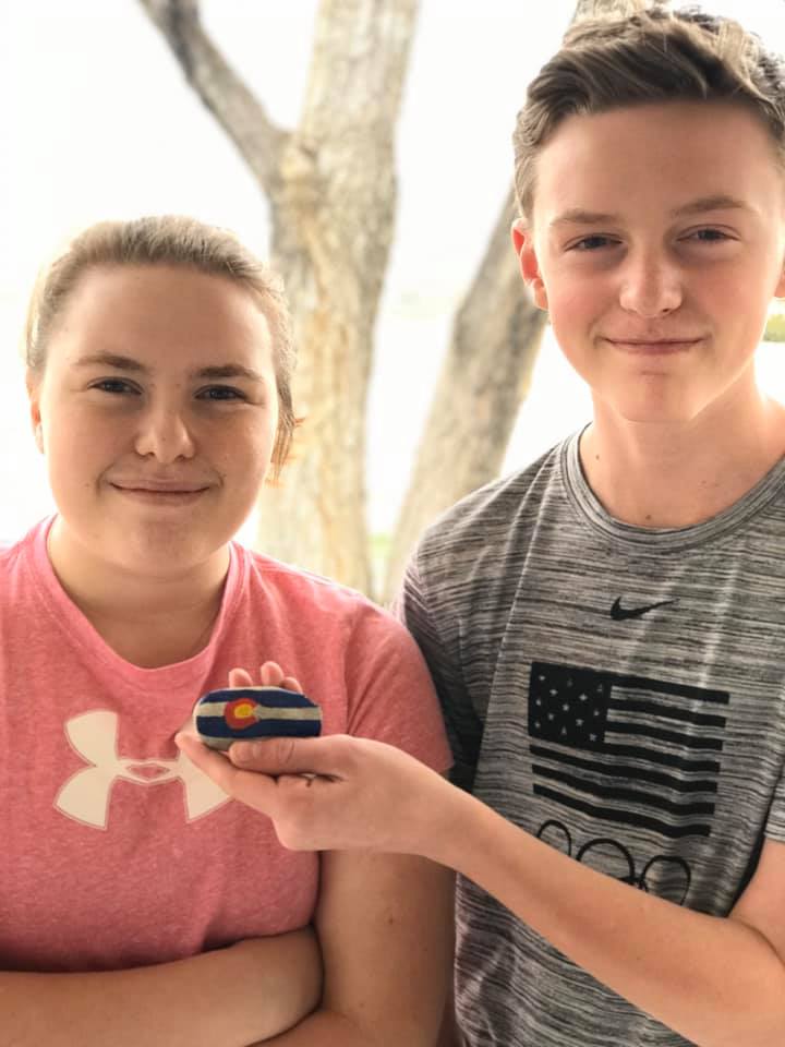 Two Dugway kids pose with a painted Colorado rock.