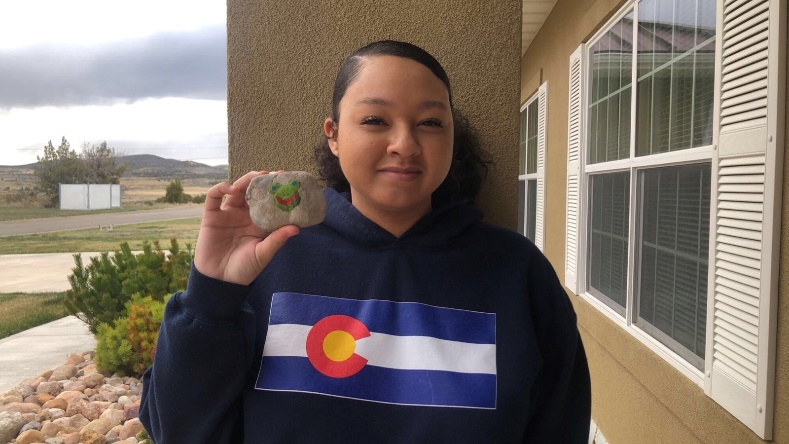 Dugways Teresa Roper poses with a painted rock she found in English Village.