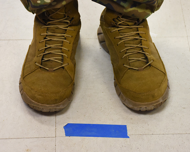 March 30, 2020 - Where your toes should be - behind the taped line. The lines are six feet apart, helping to keep people separated and reducing the risk of contracting the coronavirus. This floor is at the AAFES Shopette.