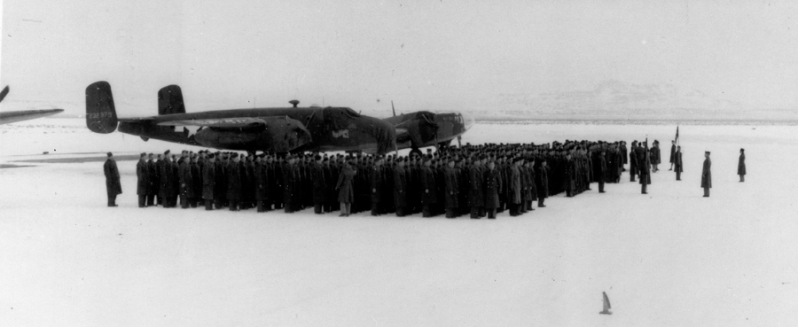 Soldiers in formation next to a B-25 Mitchell bomber, believed to be for the retirement of a master sergeant. Most of the nations B-25s were used in the Pacific, where it got low above jungles for bombing and strafing. Wonder what it was doing at Dugway?