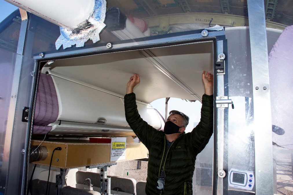 Commercial Aircraft Decontamination Efficacy Test conducted November 2020 to March 2021 at Dugway Proving Ground. The test determined if current means of neutralizing the SARS-C0V-2 virus in a passenger jet, which causes the disease COVID-19, are effective, and to possibly find even better methods. Test Officer Angelo Madonna explains how outside air passes along the vent across the top of the fuselage's ceiling and is distributed to the passengers in seats. Each passenger may also adjust personal airflow, which will also be studied