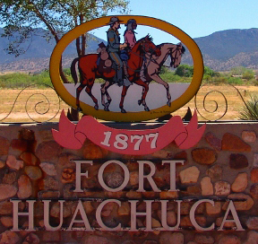 Stone wall bearing an image of two horsemen and text reading 1877 Fort Huachuca