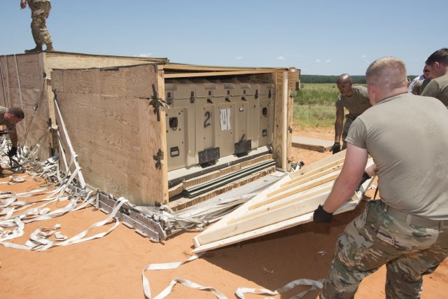 Soldiers assisting during post airdrop recovery operations of the Forward Area Supply Box (FASBOX). (Photo Credit: Jim Finney, Audio Visual Production Specialist, Airborne and Special Operations Test Directorate, U.S. Army Operational Test Command)