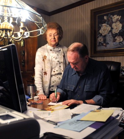 Geri watches Pete address more than 60 Christmas cards to their friends and family.