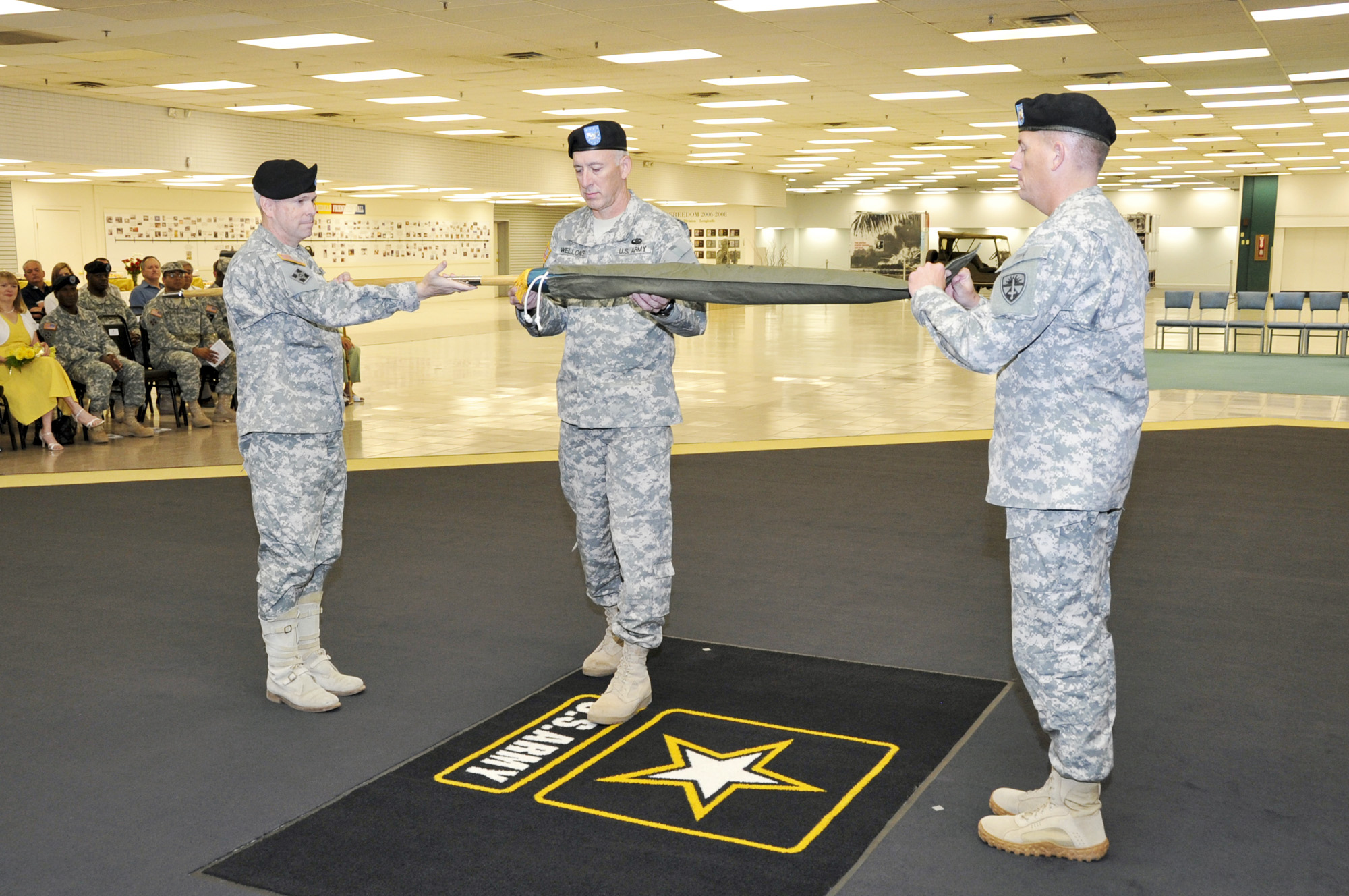 Brigadier Gen. Don MacWillie, Col. Dave Wellons and Sgt. Maj. James Cook uncase the colors for the ITED