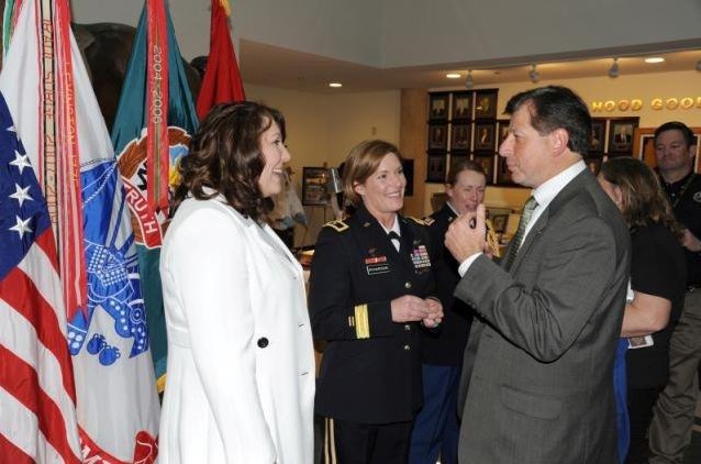 OTC Executive Director Mr. Jim Amato, right, congratulates BG Laura Richardson; daughter Lauren, left, is in receiving line after promotional ceremony