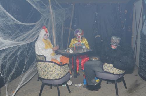 SPC Warnke, SPC Brown, and PFC Cullum play angry game of cards in haunted house