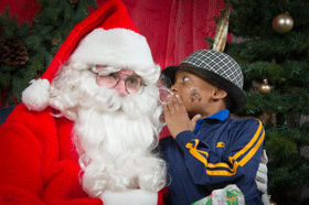 Joshua Zion whispers in Santa's ear