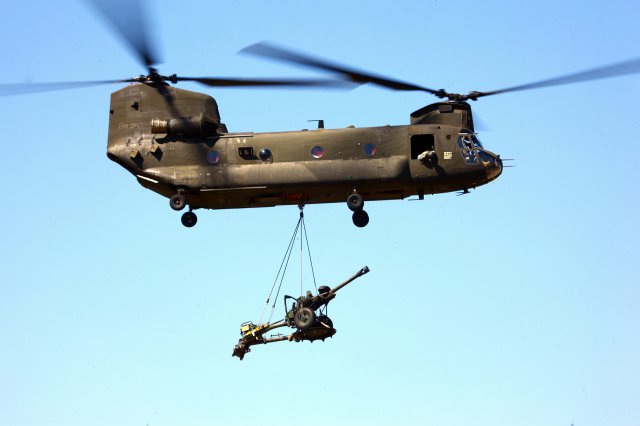 CH-47 Chinook helicopter lifts 105mm howitzer