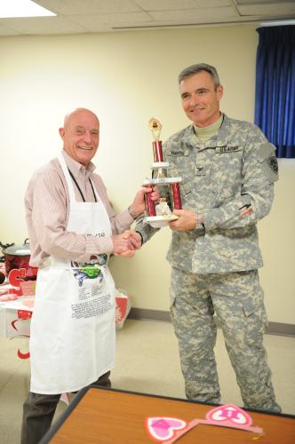 Col. Jeff Harris presents Bill Fesler with trophy for hottest chili