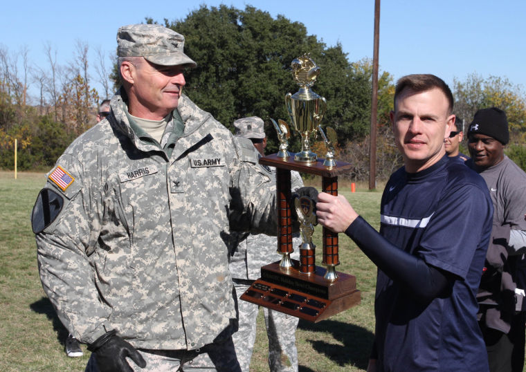 Col. Jeff Harris presents Holiday Bowl trophy to Maj. Erik Summers