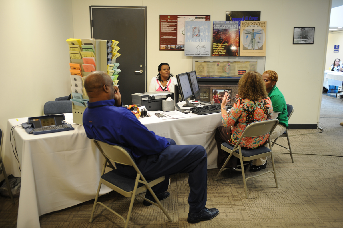 Attendees visit informational booth