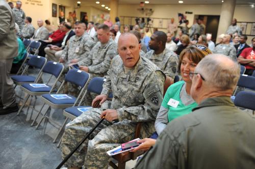 Col. Tim Karcher and his wife, Alesia, talk with friends