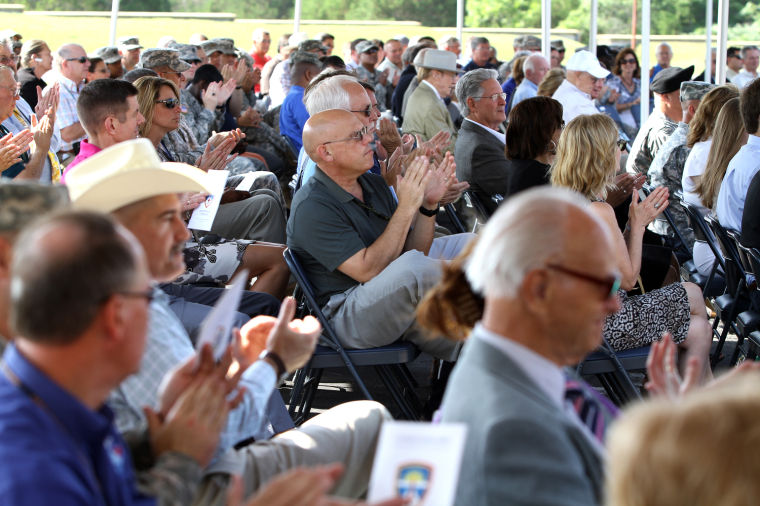 Attendees applaud during Assumption of Command ceremony