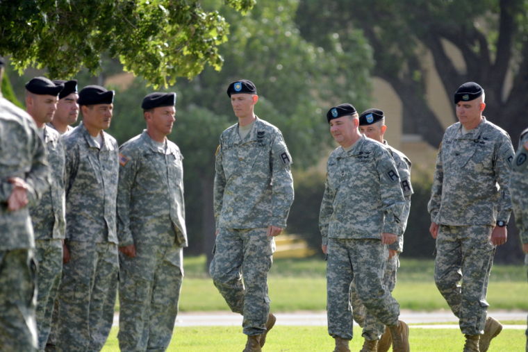 Maj. Douglas Fullerton, far left, reviews troops