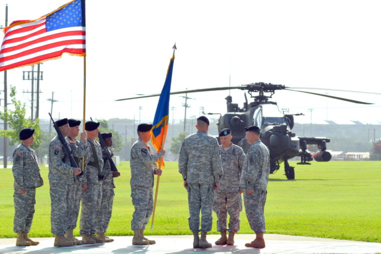 Incoming commander, Col. Christopher Albus, prepares to accept the brigade colors