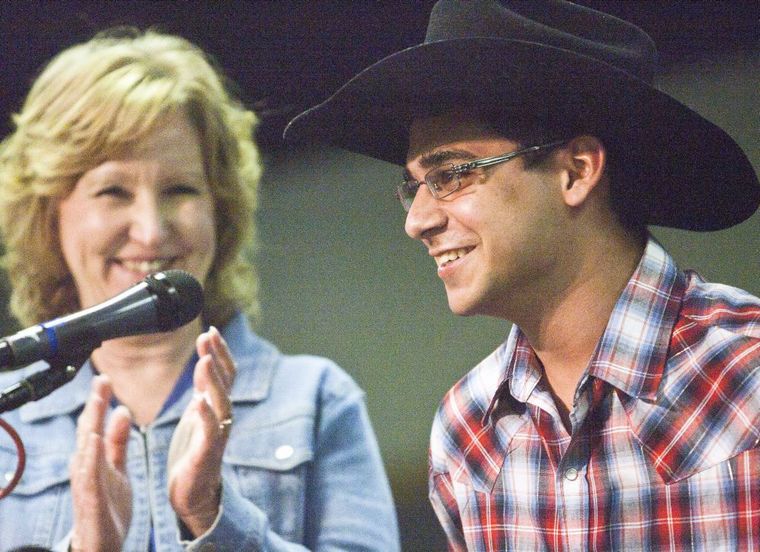 Nancy Riley, left, gives Hunter Holtsman a round of applause