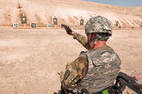 Retired Sgt. Adam Keys fires 9mm pistol at firing range