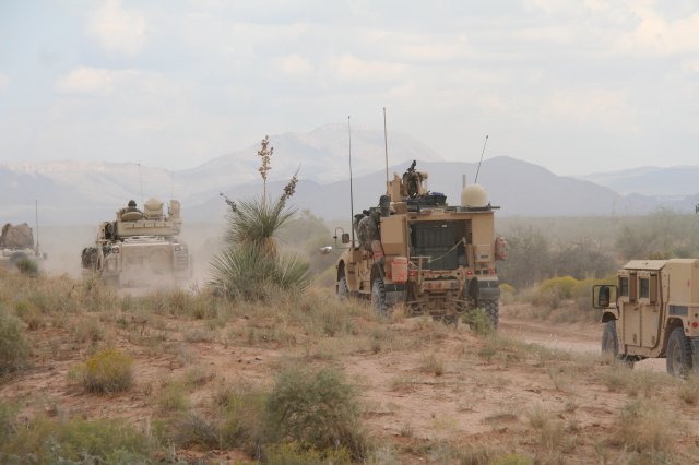 WIN-T vehicle (center right) traverses battlefield during Network Integration Evaluation 16.1