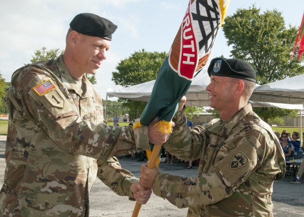 Brig. Gen. Kenneth L. Kamper (left) passes OTC's colors to Maj. Gen. Daniel L. Karbler
