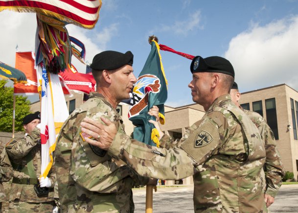 Col. John C. Ulrich (left) receives OTC's colors from Maj. Gen. Daniel L. Karbler