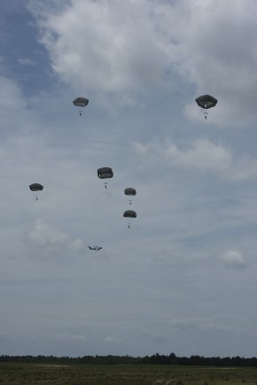 Soldiers from the 57th Sapper Company, 27th Engineer Battalion, 20th Engineer Brigade, descend under the T-11 parachute over Sicily Drop Zone, Fort Bragg, North Carolina. (Photo Credit: Jim Finney, Photographer, Combined Technical Services, Airborne and Special Operations Test Directorate, U.S. Army Operational Test Command)