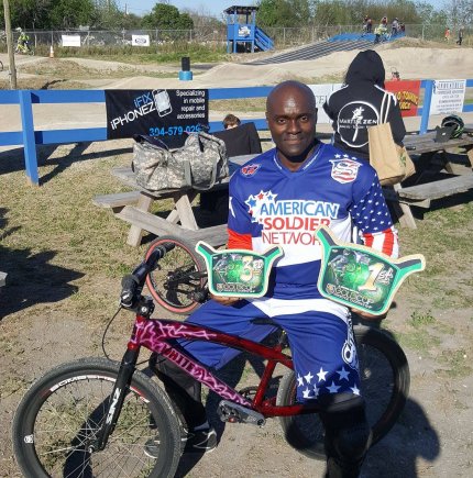 Clarence White displays trophies (Courtesy photo)