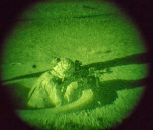 Infantryman fires his M4 carbine from foxhole