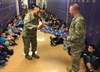 Sgt. 1st Class Benito Santos (left) and Sgt. 1st Class Jay Alan Ottinger, both research development test and evaluation (RDT&E) non-commissioned officers with Operational Test Command's Maneuver Test Directorate (MTD), show how to fold a flag during flag etiquette training for fifth-graders at Florence Elementary School, Florence Texas, on Jan. 20, 2017. (Photo Credit: Mr. Michael M Novogradac (Hood))