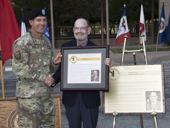 U.S. Army Operational Test Command Commander Brig. Gen John C. Ulrich presents Michael B. Nott with a framed plaque honoring his induction into the U.S. Army Operational Test Command's Operational Testers' Hall of Fame Friday. (Photo Credit: Larry Furnace, Operational Test Command Test and Documentation Team)
