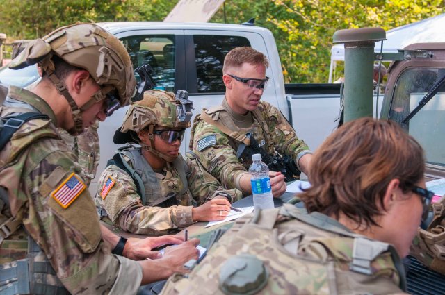 Soldiers fill out data collection sheets