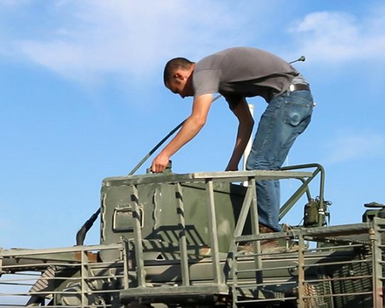 A technician prepares the Army's Stryker Nuclear, Biological, Chemical, Reconnaissance Vehicle for Joint Chemical Agent Detector system Stryker-On-The-Move tests at Target S Grid at Dugway Proving Ground, July 2017. The JCAD will be integrated with the Stryker vehicle as a replacement for the Automatic Chemical Agent Detection Alarm, which will no longer be manufactured for and fielded by the Army. Photo captured from video by Darrell L. Gray, Dugway Proving Ground Public Affairs. (Photo Credit: U.S. Army)