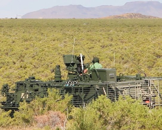 Operators on an instrumented Stryker Nuclear, Biological, Chemical, Reconnaissance Vehicle await instructions from test officers on a grid trail during Joint Chemical Agent Detector system Stryker-On-The-Move tests at Target S Grid at Dugway Proving Ground, July 2017. Dugway's data gathering capabilities, large area, and technical expertise made it the perfect location for the system tests. Photo captured from video by Darrell L. Gray, Dugway Proving Ground Public Affairs. (Photo Credit: U.S. Army)