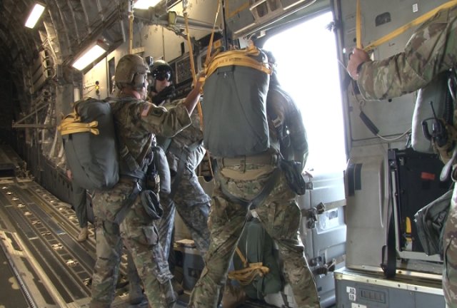 "Black Falcon" Soldiers get ready to push a JETS door bundle out of airplane