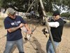 Aurelio Luna (left), spouse of a USAOTC Army Civilian employee, joins Maj. Peter Moore, a test officer with USAOTC's Mission Command Test Directorate, in mending swing set chains at the Florence ISD Elementary School playground on "Make A Difference Day." (Photo Credit: Mr. Michael M Novogradac (Hood))