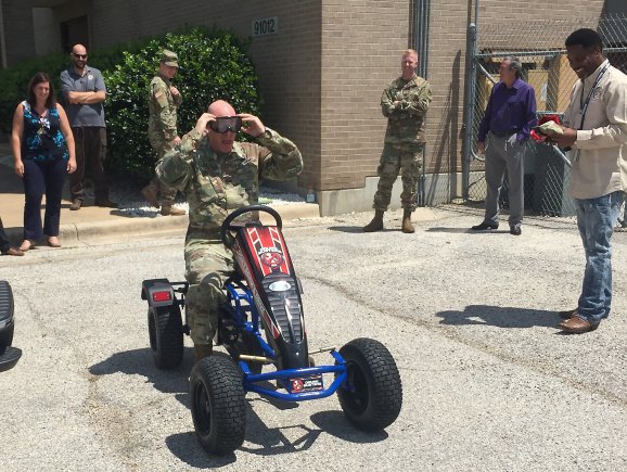 Col. Ted. D. Yates, U.S. Army Operational Test Command's future operations officer, puts on "drunk goggles" during directorate safety training Aug. 30 during the command's safety stand down. (Photo Credit: Staff Sgt. Scott D. Pangelinan, Operations NCO, U.S. Army Operational Test Command Public Affairs)