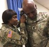 Spc. Martha Ngenue, an ear, nose and throat specialist with the Carl R. Darnall Army Medical Center Preventive Medicine Clinic, checks the ear canal for obstructions and ear plug size for Lt. Col. Brian Robinson, a senior planner with the U.S. Army Operational Test Command's Operations Directorate, during OTC's safety stand down Aug. 30. (Photo Credit: Mr. Michael M Novogradac (Hood))