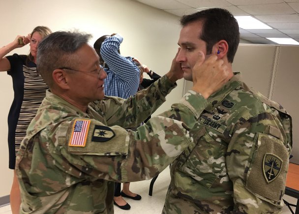 Lt. Col. Dan Ohama (left) gives a "thumbs-up" on ear plugs fitted to U.S. Army Operational Test Command Aviation Test Officer Maj. Olin L. Walters. Ohama is chief of the Ear, Nose, and Throat clinic at Carl R. Darnall Army Medical Center and was on-hand for OTC's command safety stand down Aug. 30, providing a hearing conservation class and ear plug fitting for all OTC employees. (Photo Credit: Mr. Michael M Novogradac (Hood))