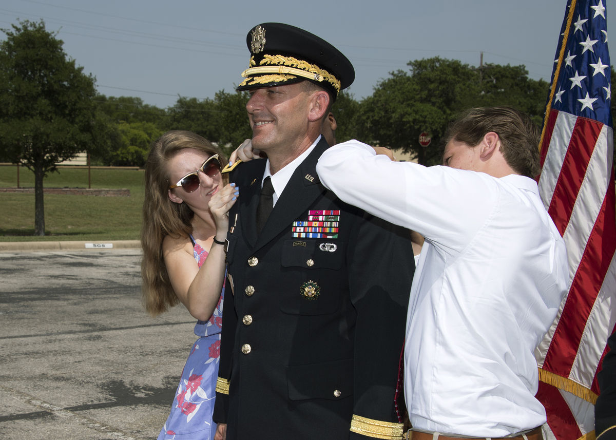 Col. John Ulrich receives new brigadier general rank from daughter Chelsea and son Ethan (photo by Larry Furnace, OTC Test and Documentation Team)